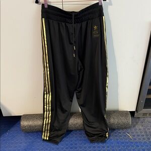 adidas adult Black Joggers with Gold Accents.